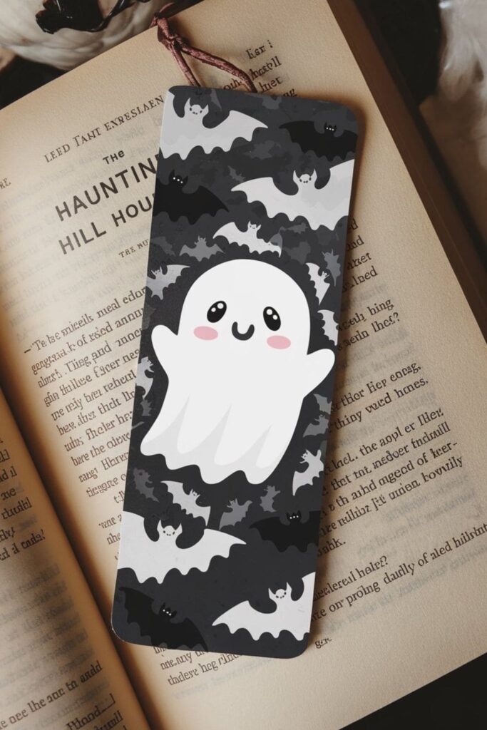 A Halloween-inspired bookmark featuring ghost and bat silhouettes, dark colors, and glow-in-the-dark paint for a spooky and eerie effect