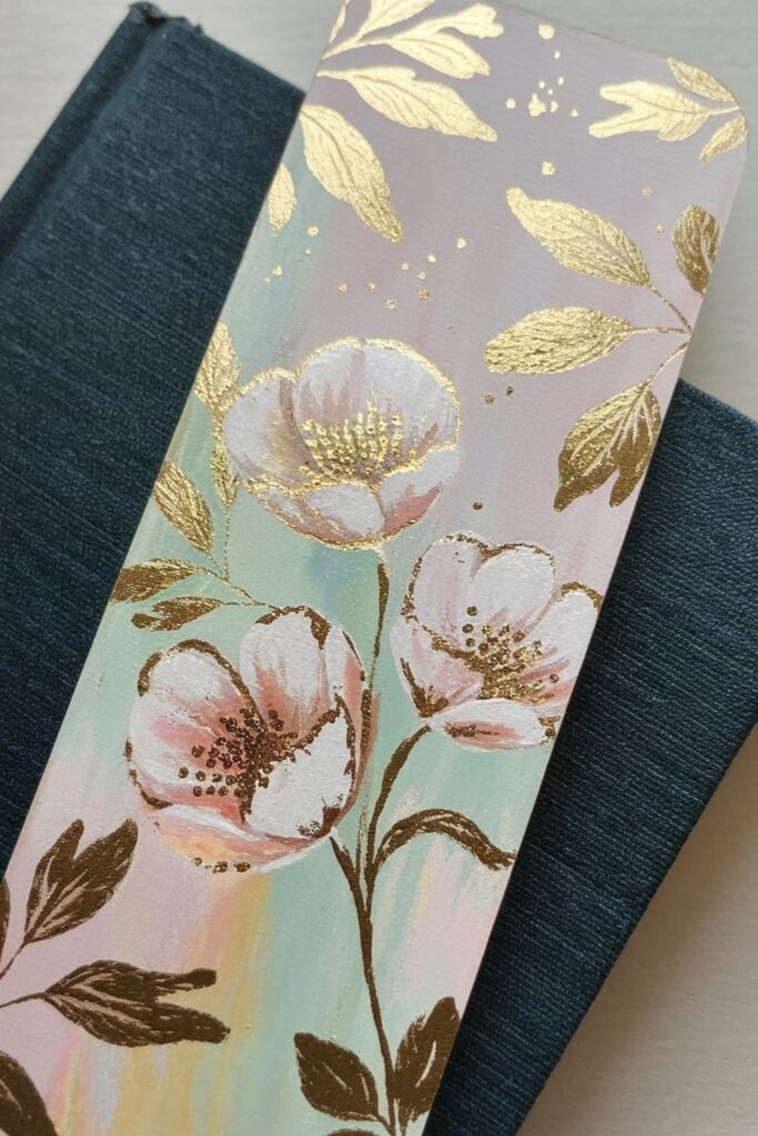 A luxurious bookmark featuring intricate floral designs enhanced with shimmering gold leaf detailing, adding a touch of elegance and sophistication